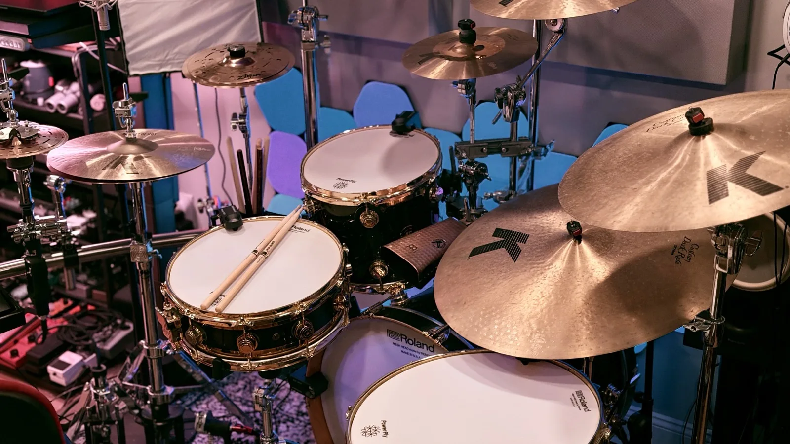 The earlier DW hybrid setup with mesh heads, Roland triggers, a triggered DW snare, and Zildjian K cymbals