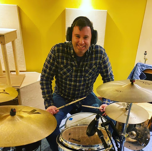 Tyler Ingersoll seated at a drum kit during a recording session